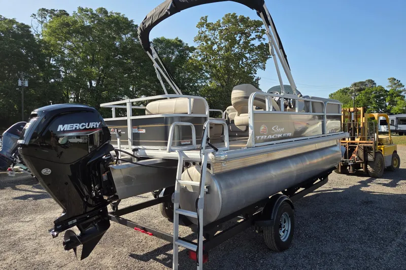 Slide: The Image of 2022 Sun Tracker Party Barge 18 DLX pontoon boat with Mercury engine on trailer. - 4