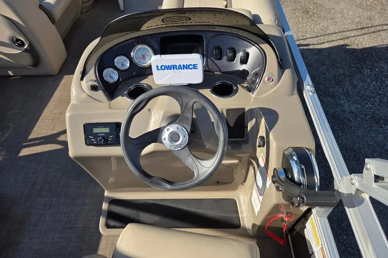 Slide: The Image of 2022 Sun Tracker Party Barge 18 DLX dashboard with steering wheel and Lowrance display. - 9