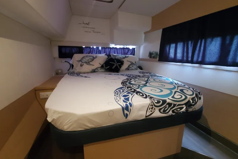 Slide: The Image of Cozy bedroom in 2018 Fountaine Pajot Helia 44 Evolution catamaran with turtle-themed bedding. - 10