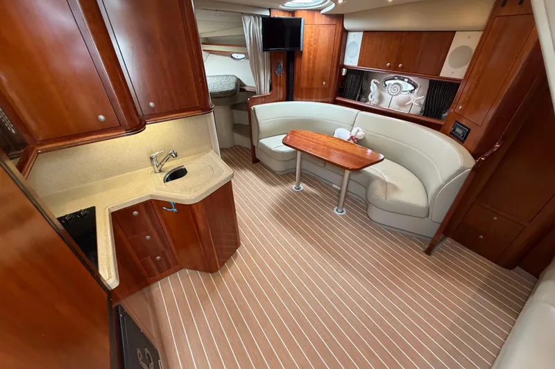 Slide: The Image of Luxurious interior of 2007 Cruisers Yachts 370 Express with elegant wood cabinetry and plush seating. - 15
