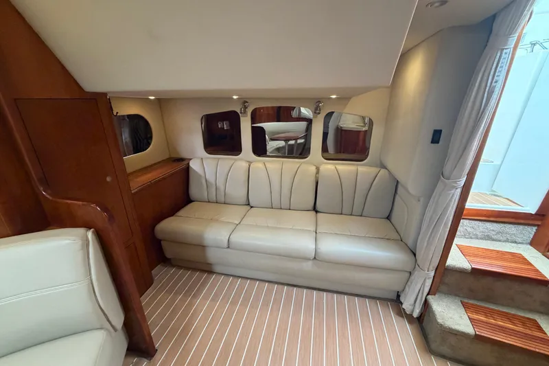 Slide: The Image of Luxurious interior of 2007 Cruisers Yachts 370 Express with cream leather seating and wood accents. - 17