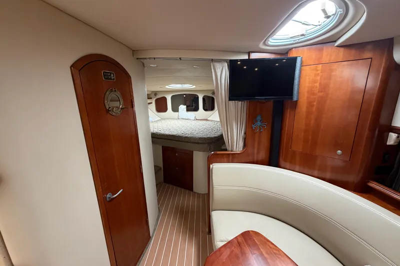 Slide: The Image of Luxurious 2007 Cruisers Yachts 370 Express cabin interior with wood finishes and cozy seating. - 19