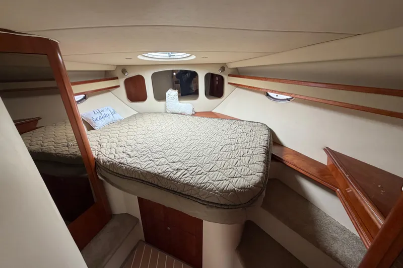 Slide: The Image of Cozy cabin interior of 2007 Cruisers Yachts 370 Express with plush bedding and wooden accents. - 20
