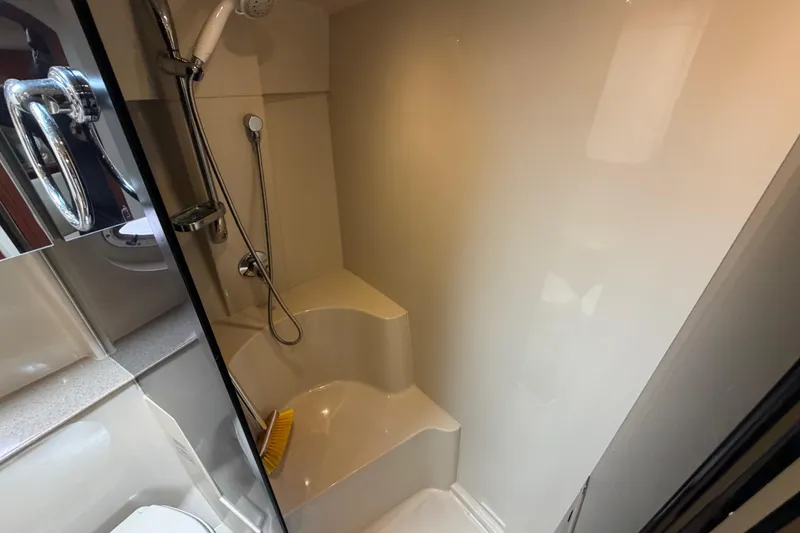Slide: The Image of Shower area in 2007 Cruisers Yachts 370 Express, featuring a handheld showerhead and seating. - 23