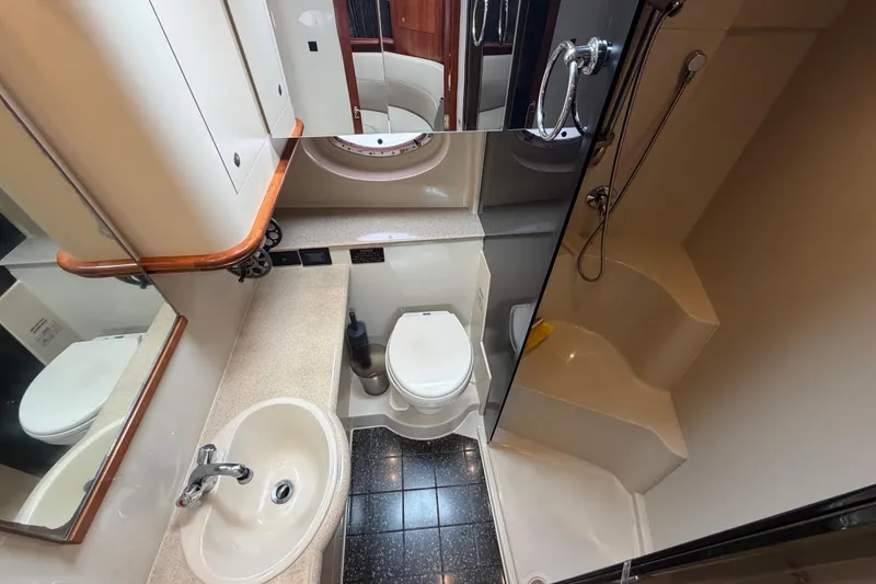 Slide: The Image of Luxurious bathroom in 2007 Cruisers Yachts 370 Express, featuring sink, toilet, and shower. - 24