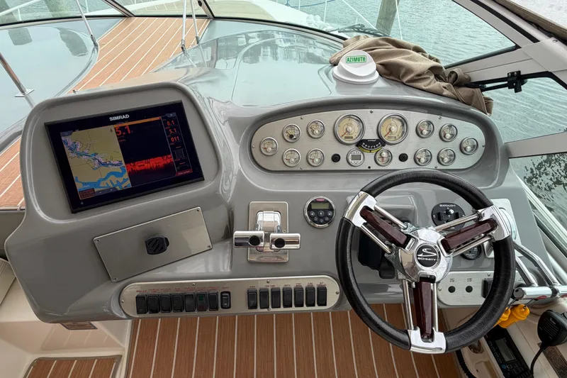 Slide: The Image of 2007 Cruisers Yachts 370 Express helm with navigation display and steering wheel. - 25