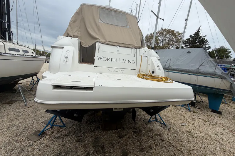 Slide: The Image of 2007 Cruisers Yachts 370 Express on stands, rear view with cover and "Worth Living" text. - 31
