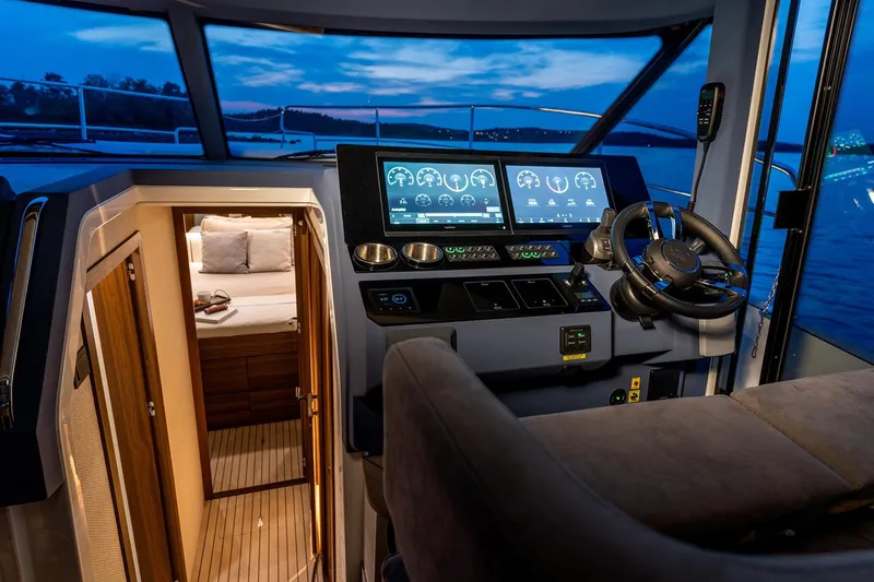 Slide: The Image of Manufacturer Provided Image: 2025 Marex 440 Scandinavia yacht cockpit with modern controls and cabin view at dusk. - 9