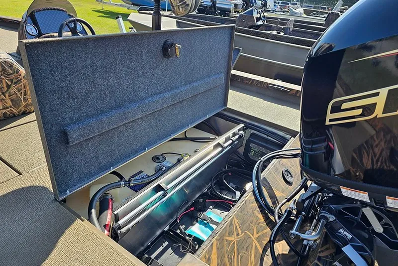 Slide: The Image of 2026 G3 Sportsman 1810 boat interior with open storage compartment and visible engine components. - 11