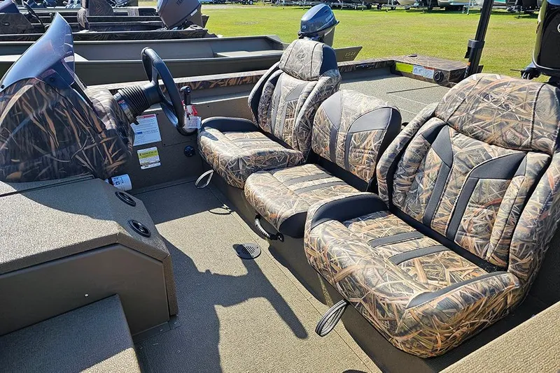 Slide: The Image of 2026 G3 Sportsman 1810 boat interior with camo-patterned seats and steering wheel. - 12