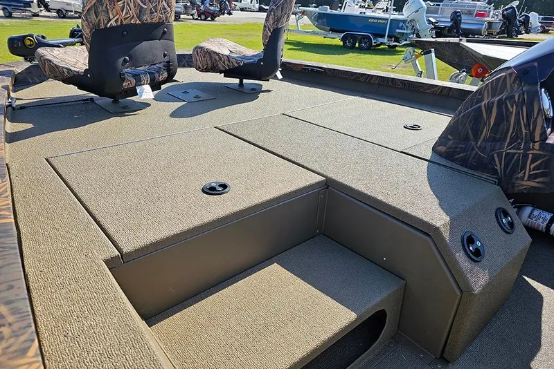 Slide: The Image of 2026 G3 Sportsman 1810 boat interior with camo seats and storage compartments. - 14
