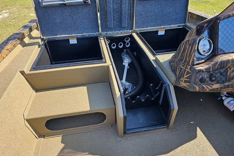 Slide: The Image of 2026 G3 Sportsman 1810 boat interior with open storage compartments and dashboard details. - 16