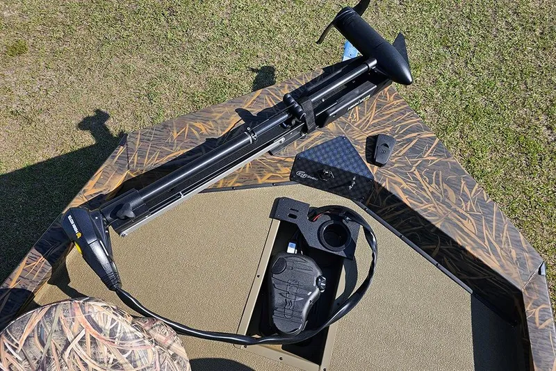 Slide: The Image of 2026 G3 Sportsman 1810 boat deck with trolling motor and camouflage design. - 20