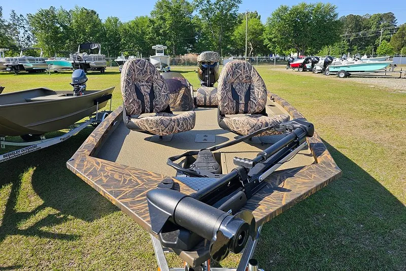 Slide: The Image of 2026 G3 Sportsman 1810 boat with camouflage seats on display outdoors. - 4