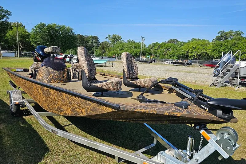 Slide: The Image of 2026 G3 Sportsman 1810 boat with camouflage seats on a trailer, parked outdoors. - 5