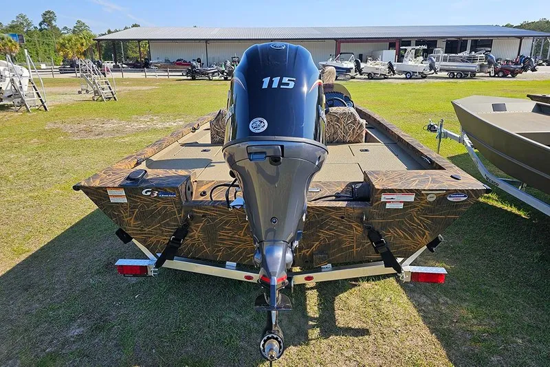 Slide: The Image of 2026 G3 Sportsman 1810 boat with powerful 115 engine, parked outdoors on grass. - 7