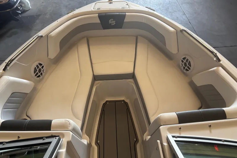 Slide: The Image of 2022 Chaparral 21 Surf boat interior with cushioned seating and speakers. - 5