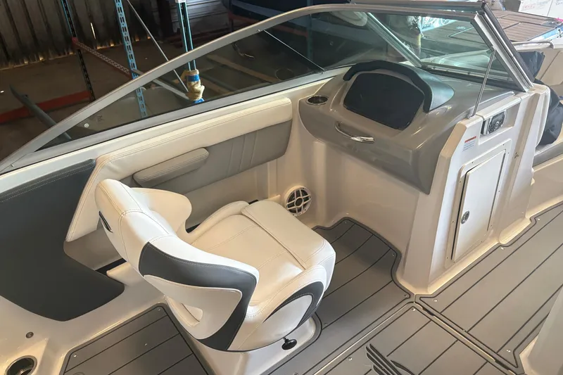 Slide: The Image of 2022 Chaparral 21 Surf boat interior with white seating and modern dashboard. - 6