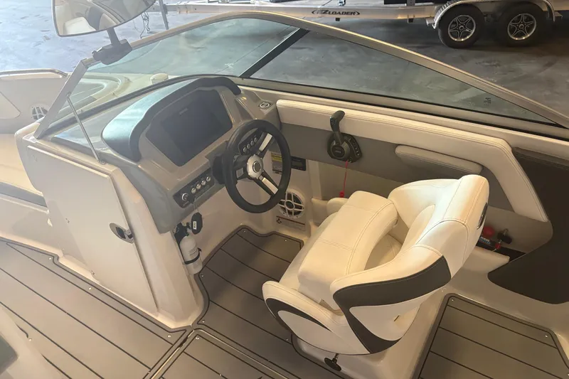 Slide: The Image of Interior view of 2022 Chaparral 21 Surf boat cockpit with steering wheel and seating. - 7