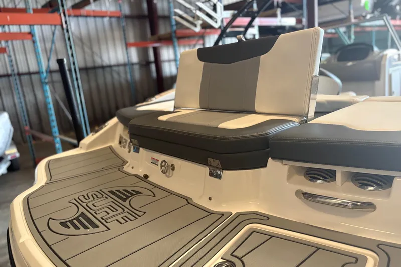 Slide: The Image of 2022 Chaparral 21 Surf boat interior with cushioned seating and deck design. - 9