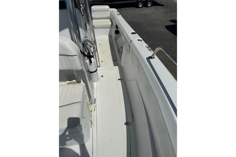 Slide: The Image of 2007 Triumph 215 TE boat interior with white seating and stainless steel railings. - 10