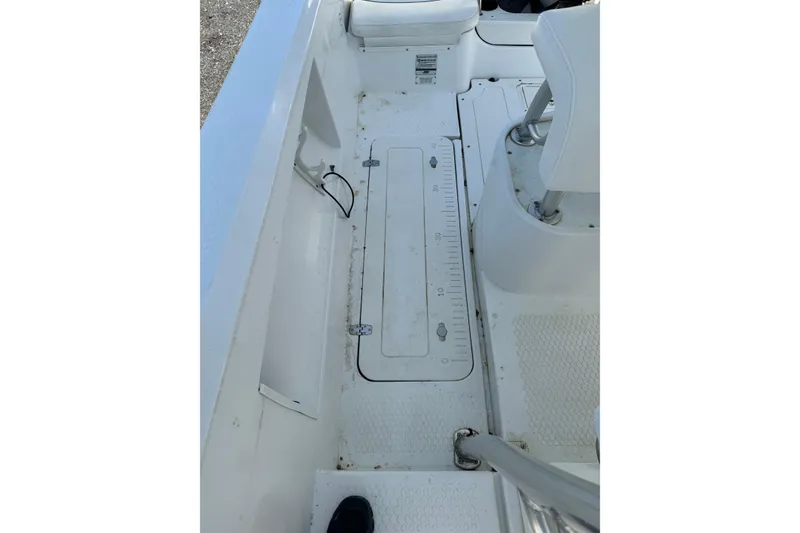 Slide: The Image of 2007 Triumph 215 TE boat interior with white seating and deck details. - 11