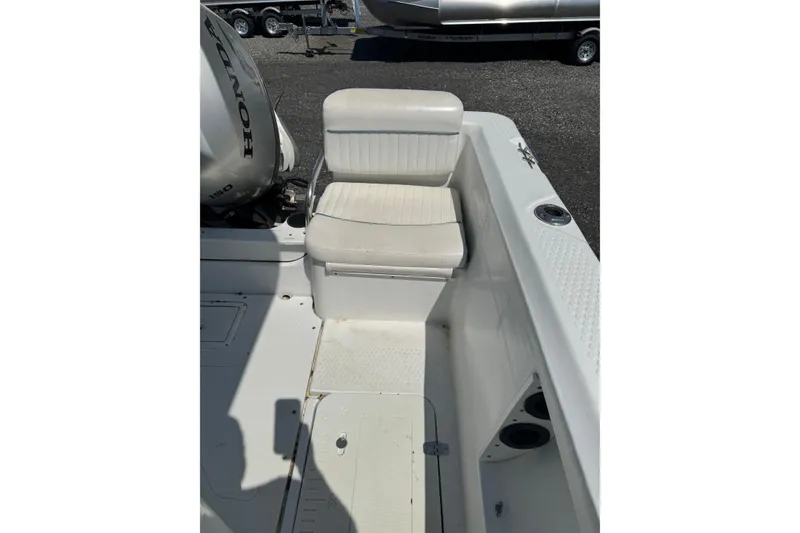 Slide: The Image of 2007 Triumph 215 TE boat interior with Honda engine, featuring white seating and deck. - 12