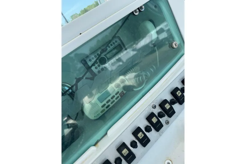 Slide: The Image of Control panel of a 2007 Triumph 215 TE boat with radio and switches. - 13
