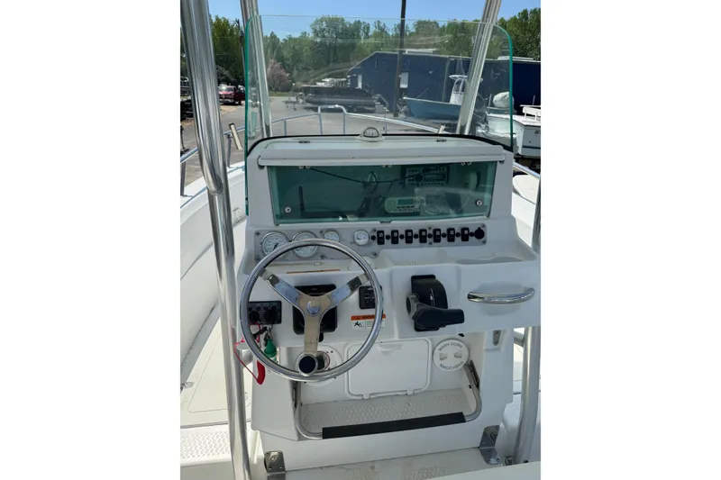 Slide: The Image of Center console of a 2007 Triumph 215 TE boat with steering wheel and controls. - 4