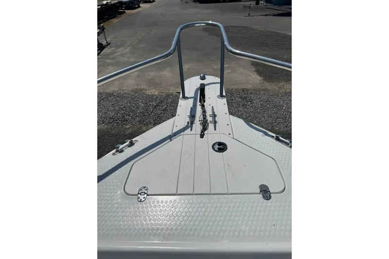 Slide: The Image of 2007 Triumph 215 TE boat deck with railings and hatch, parked on gravel. - 6