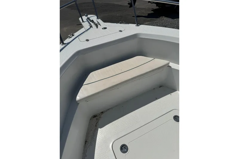 Slide: The Image of Bow seating area of a 2007 Triumph 215 TE boat, featuring white cushioned seat. - 7