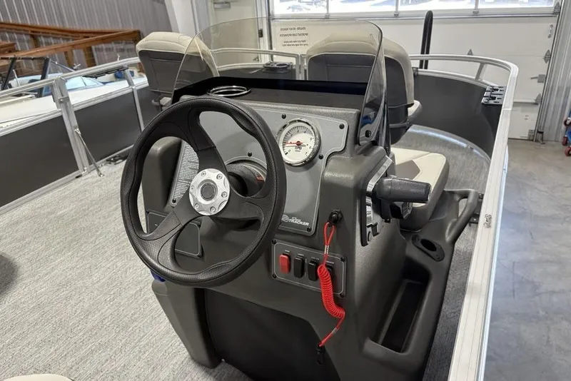 Slide: The Image of 2026 Sun Tracker Bass Buggy 16 XL Select boat dashboard with steering wheel and controls. - 19