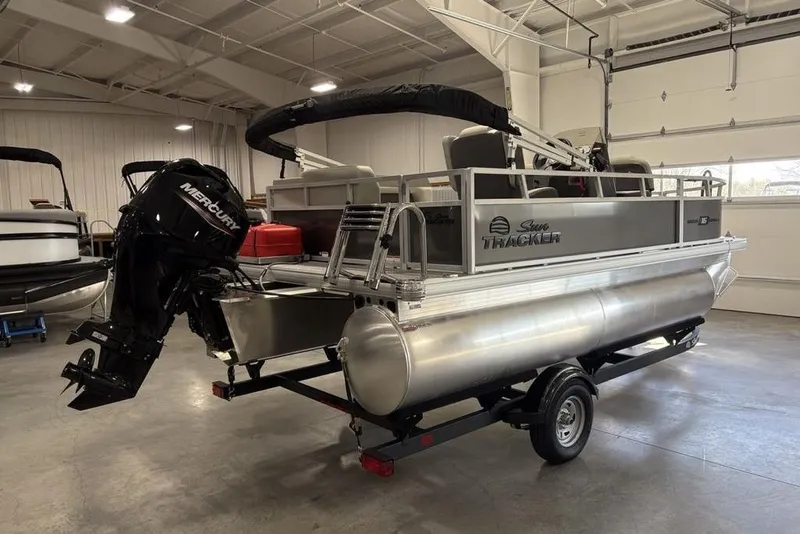 Slide: The Image of 2026 Sun Tracker Bass Buggy 16 XL Select pontoon boat in a showroom. - 4