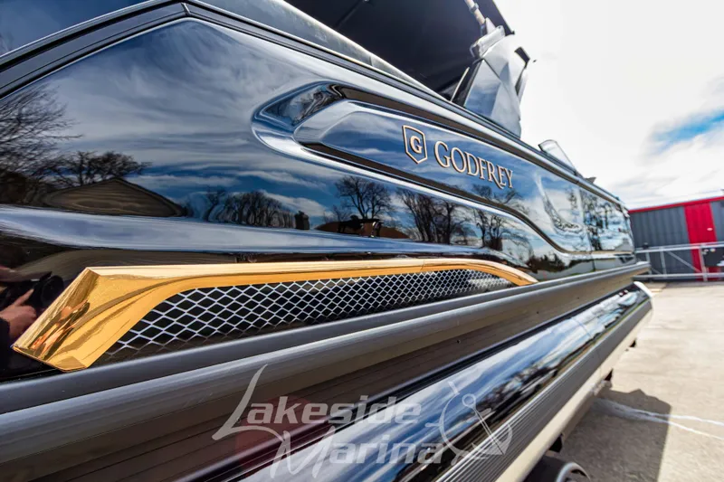 Slide: The Image of 2026 Godfrey Sanpan 2700 ULW Twin pontoon boat with sleek black and gold design. - 12