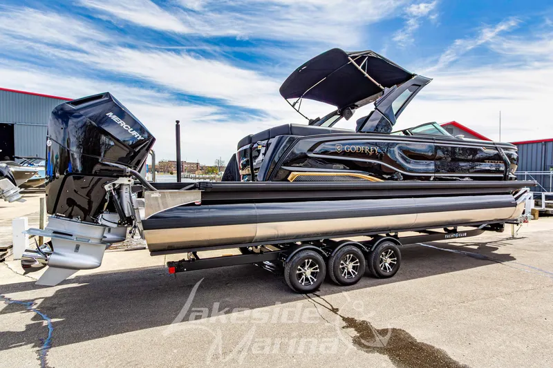 Slide: The Image of 2026 Godfrey Sanpan 2700 ULW Twin pontoon boat with dual Mercury engines on trailer. - 3