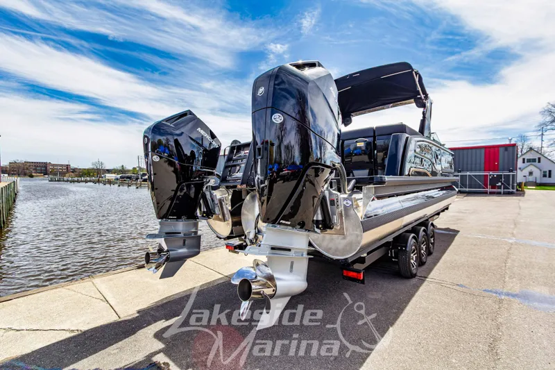 Slide: The Image of 2026 Godfrey Sanpan 2700 ULW Twin pontoon boat with dual engines at marina dock. - 4