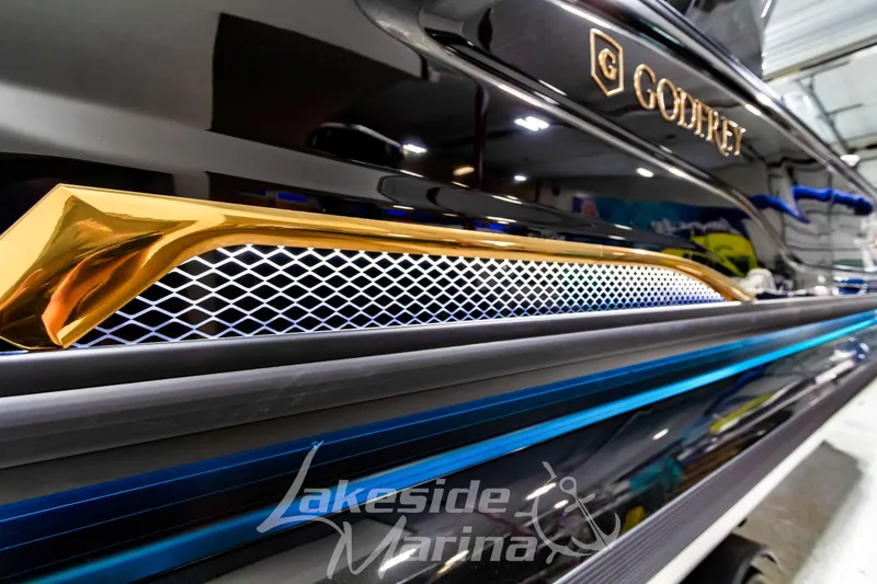 Slide: The Image of Close-up of 2026 Godfrey Sanpan 2700 ULW Twin boat with gold and blue accents. - 55