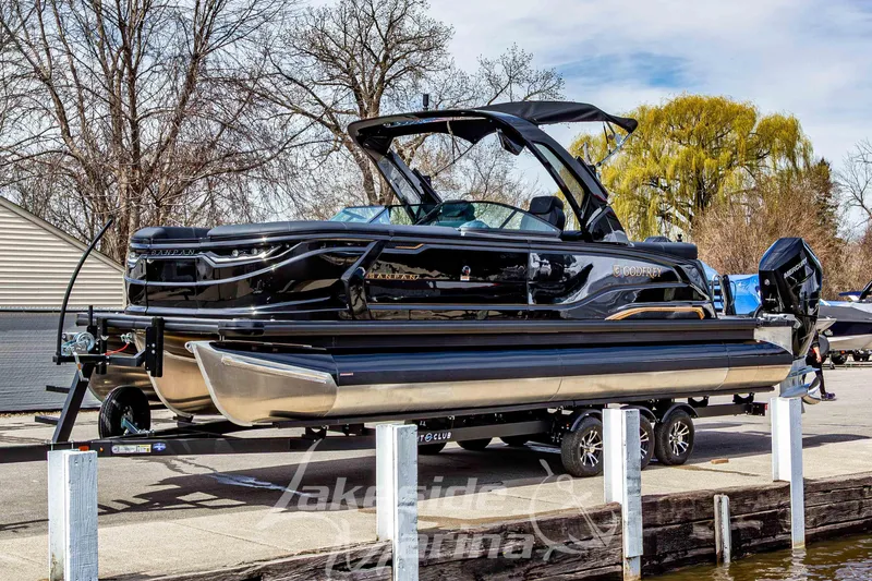 Slide: The Image of 2026 Godfrey Sanpan 2700 ULW Twin pontoon boat on trailer at marina. - 8