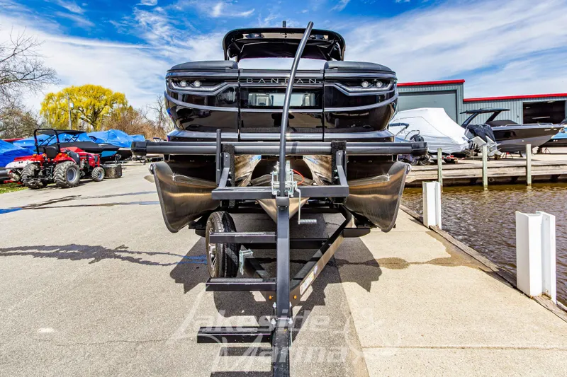 Slide: The Image of 2026 Godfrey Sanpan 2700 ULW Twin pontoon boat on trailer at marina dock. - 9