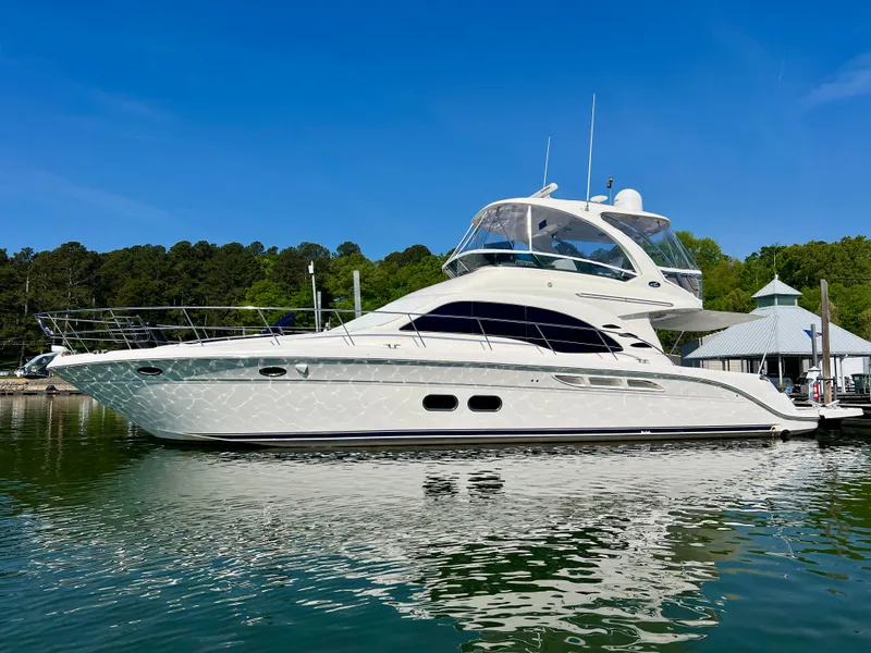 The Image of 2007 Sea Ray 52 Sedan Bridge yacht docked, blue sky. - 0