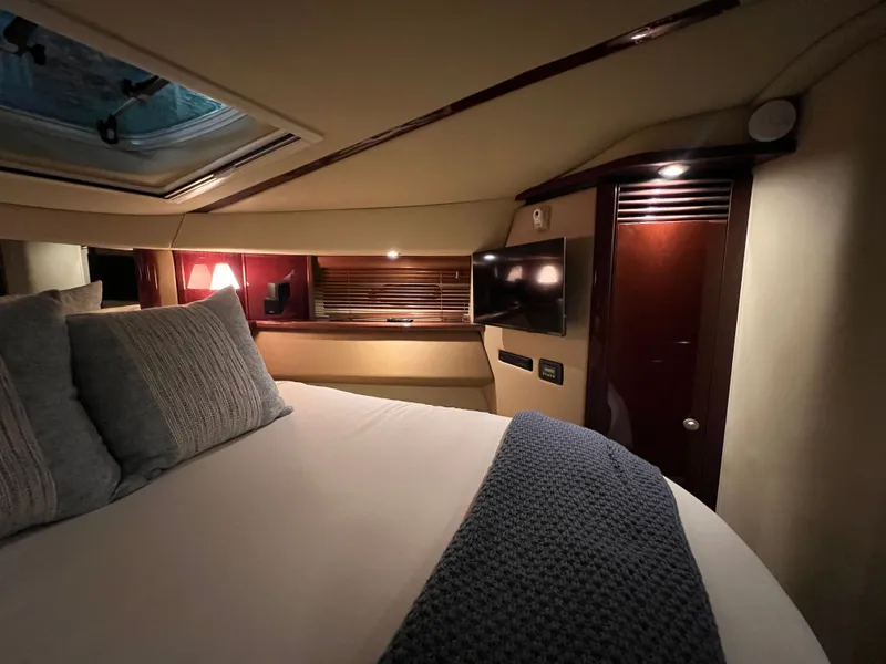 Slide: The Image of Luxurious cabin of 2007 Sea Ray 52 Sedan Bridge with bed and TV. - 22