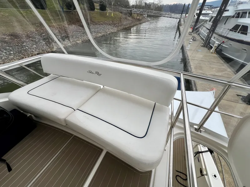 Slide: The Image of 2007 Sea Ray 52 Sedan Bridge with white seating area at dock. - 34