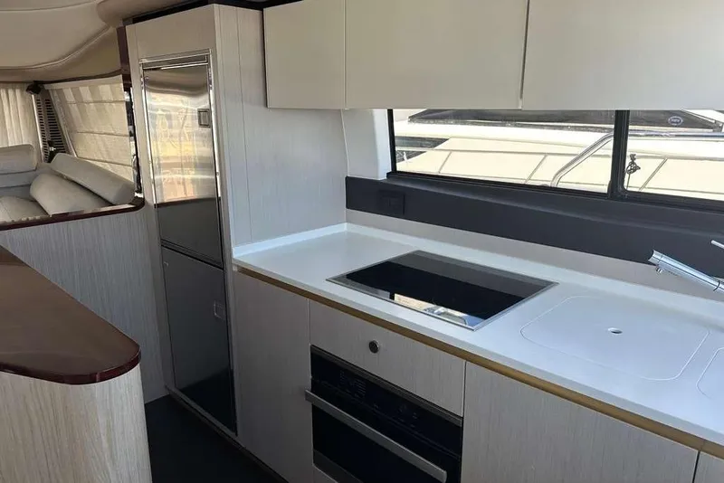 Slide: The Image of Modern kitchen interior of 2021 Azimut Fly 60 yacht with sleek appliances and cabinetry. - 10