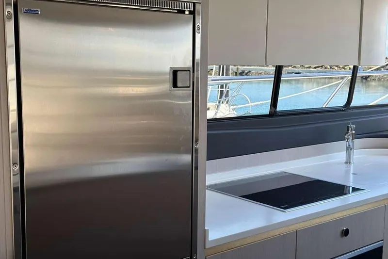 Slide: The Image of Modern kitchen interior on 2021 Azimut Fly 60 yacht with stainless steel fridge and sleek countertop. - 11