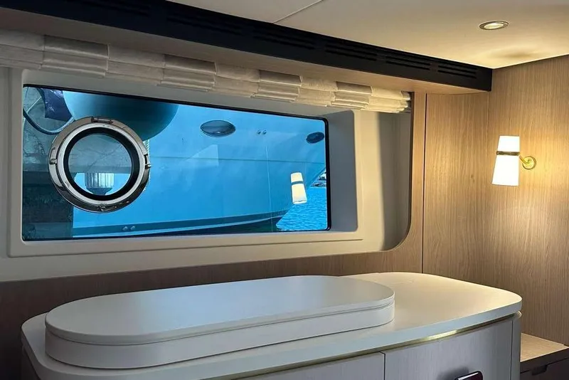 Slide: The Image of Interior of 2021 Azimut Fly 60 yacht with window view and elegant lighting. - 12