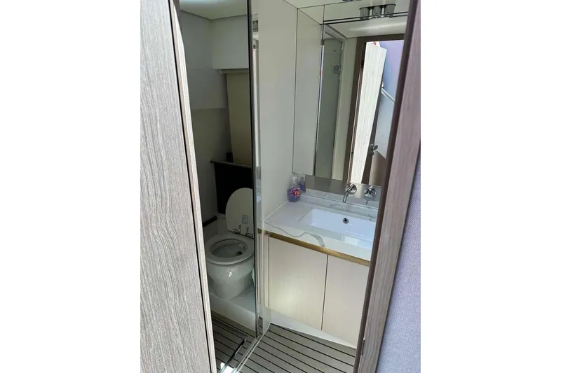 Slide: The Image of Bathroom interior of 2021 Azimut Fly 60 yacht, featuring modern sink and toilet. - 17