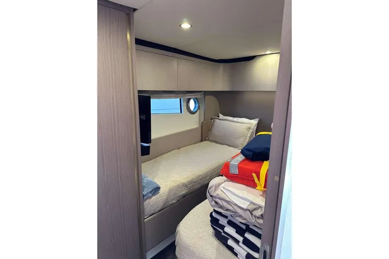 Slide: The Image of Cozy cabin interior of 2021 Azimut Fly 60 yacht with bed and porthole window. - 19