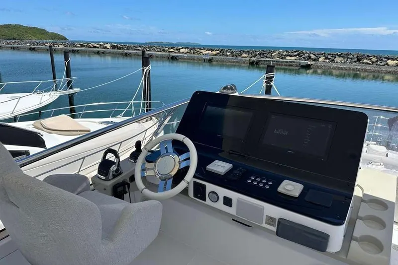 Slide: The Image of Cockpit view of 2021 Azimut Fly 60 yacht docked by the water. - 28