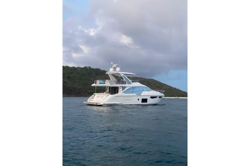 Slide: The Image of 2021 Azimut Fly 60 yacht on calm waters with scenic backdrop. - 30