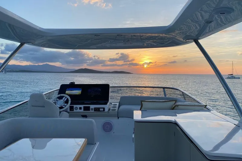 Slide: The Image of Luxurious 2021 Azimut Fly 60 yacht at sunset, overlooking serene ocean and distant islands. - 31